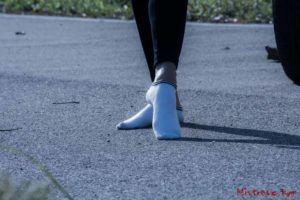 Walking with white socks and naked ankles Kym alone